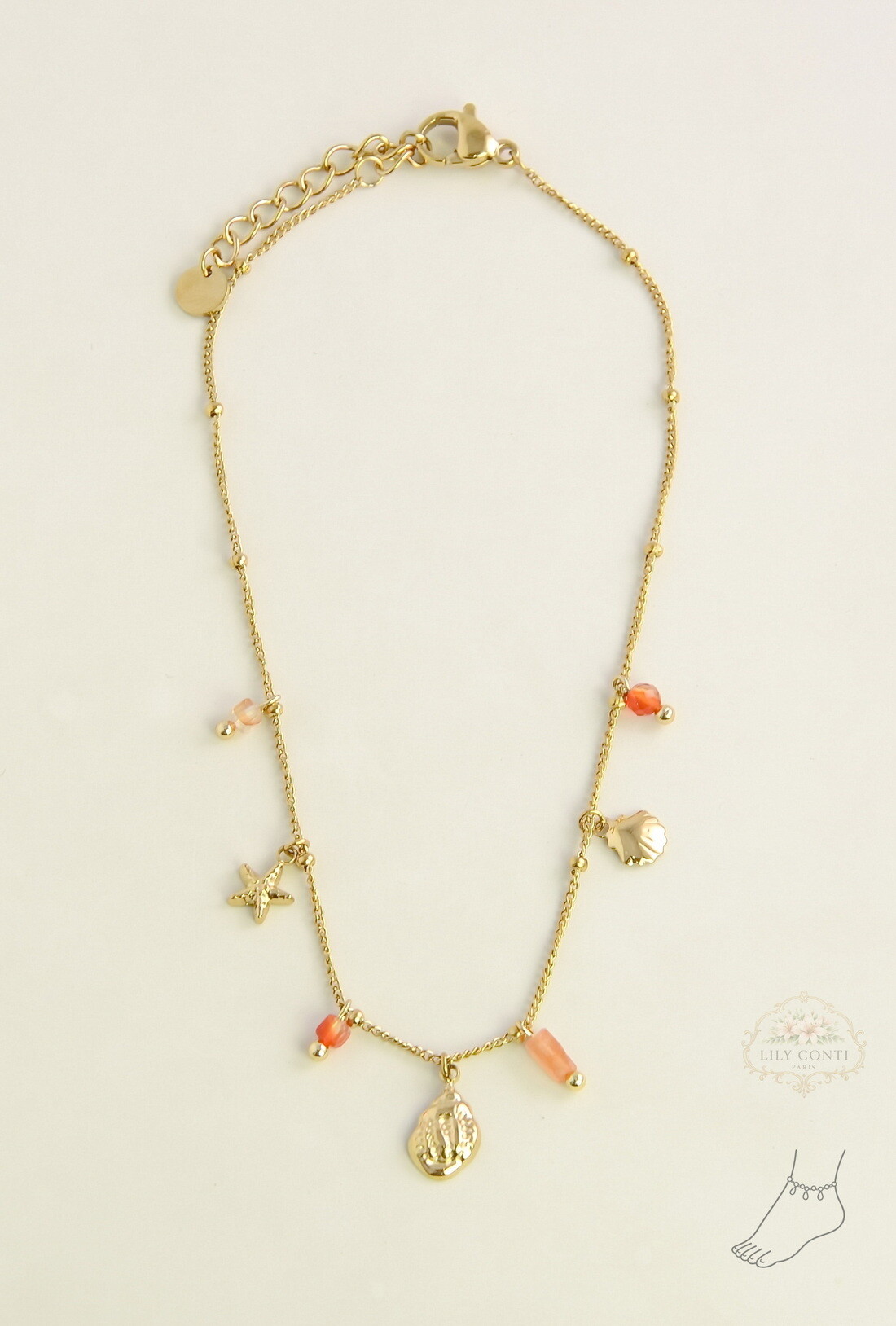 Mayorista LILY CONTI - Tobillera dorada de acero inoxidable con piedras facetadas y dijes marinos