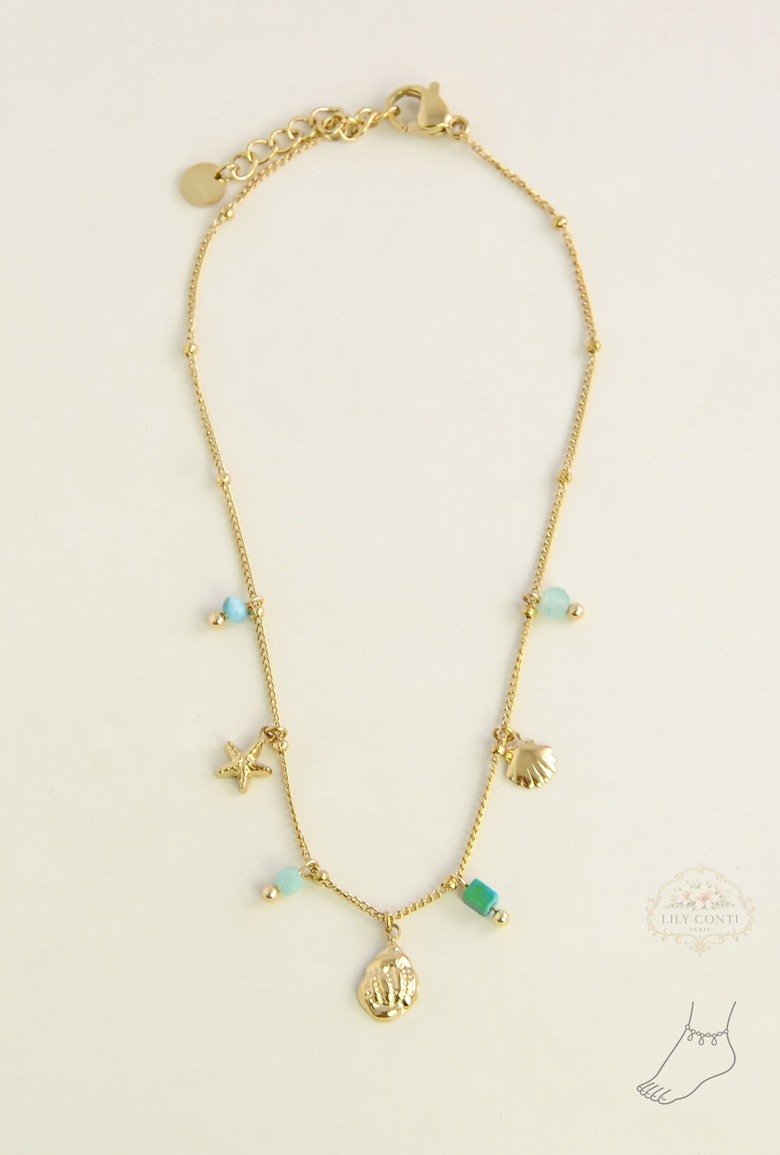 Mayorista LILY CONTI - Tobillera dorada de acero inoxidable con piedras facetadas y dijes marinos
