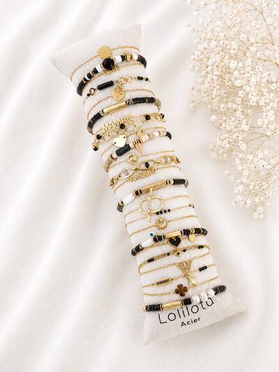 Grossista Lolilota - set di 24 braccialetti neri e dorati Grossista Lolilota - set di 24 braccialetti neri e dorati