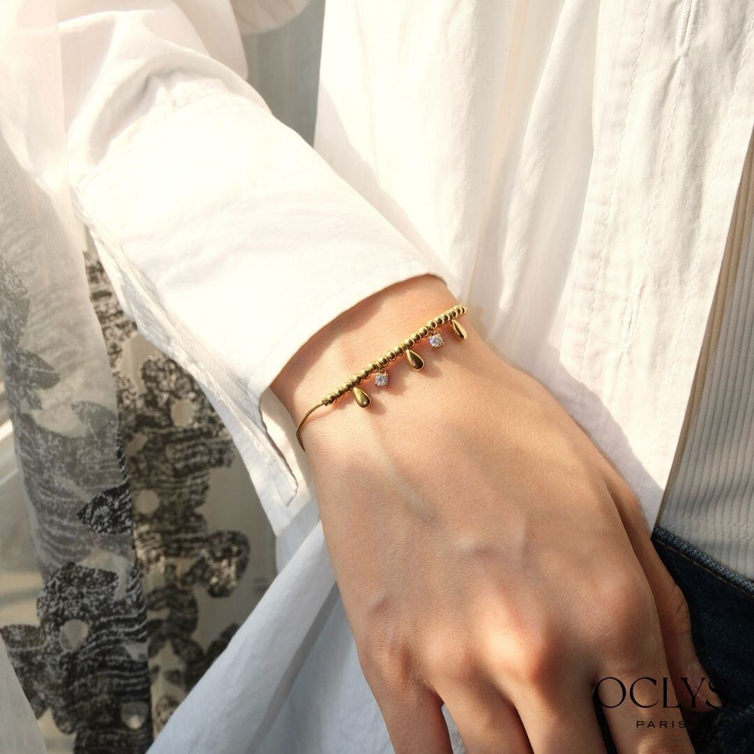 Grossista OCLYS - Bracciale con ciondoli dorato Pona in acciaio inossidabile con strass
