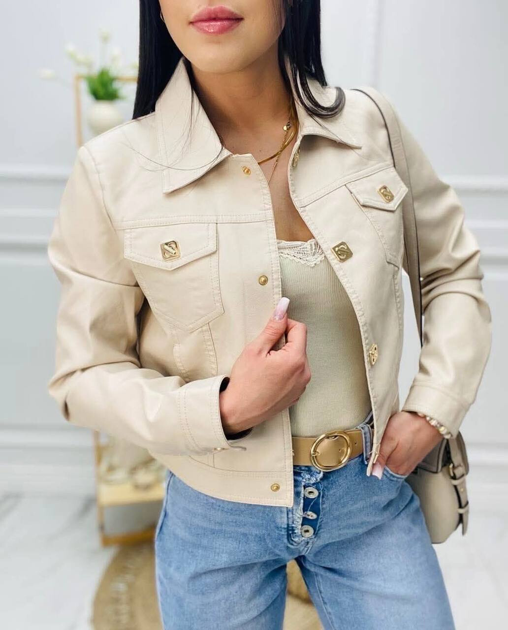 Faux leather jacket, lapel collar, snap button closure, golden finishes.