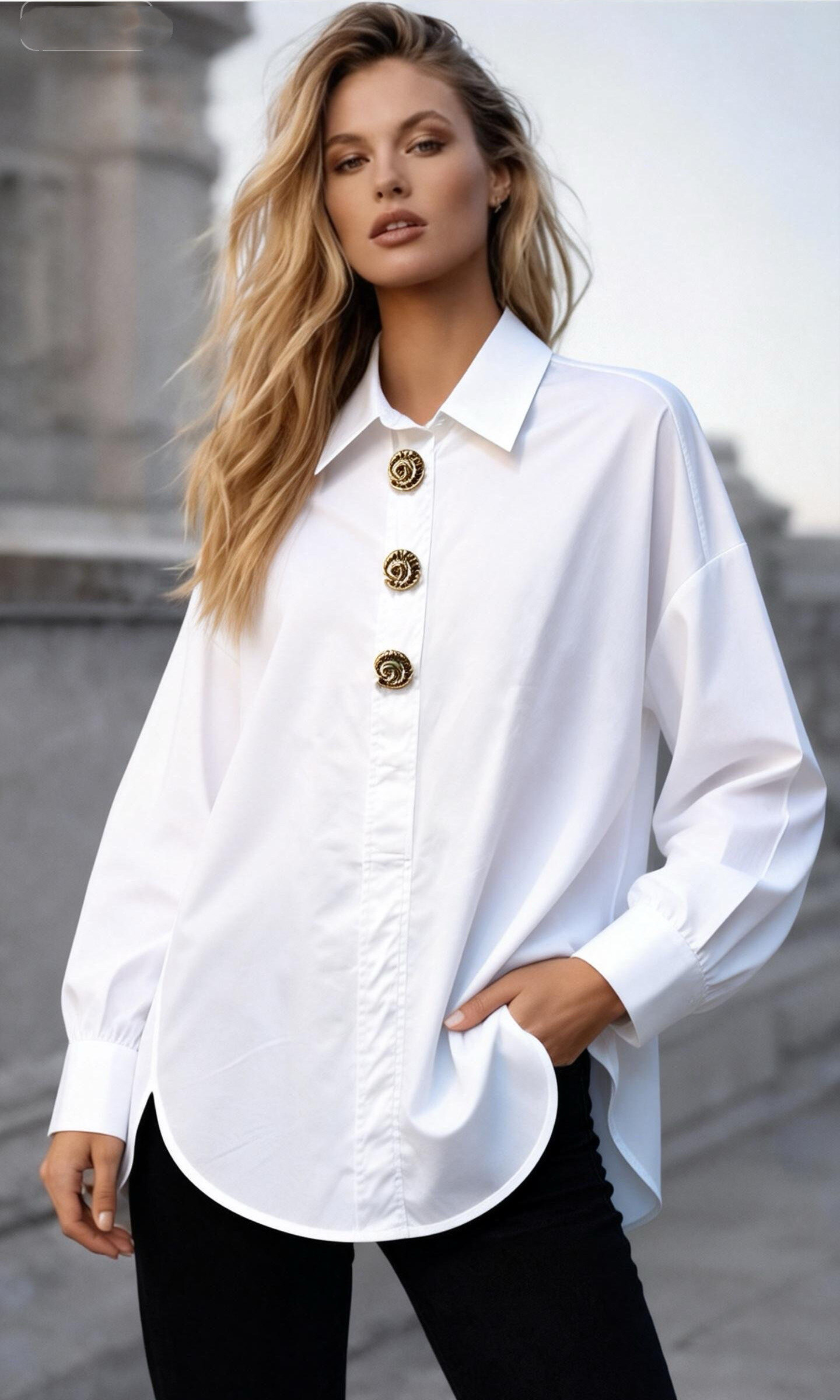 Women's shirt with a straight, flowing cut, designed for an elegant and comfortable fit. It is distinguished by its decorative buttons with a textured design which add a refined touch. Featuring a classic collar and long sleeves with buttoned cuffs, this piece is suitable for both a casual outfit and a more formal look. Easy to combine, it is suitable for everyday use as well as for more formal occasions.