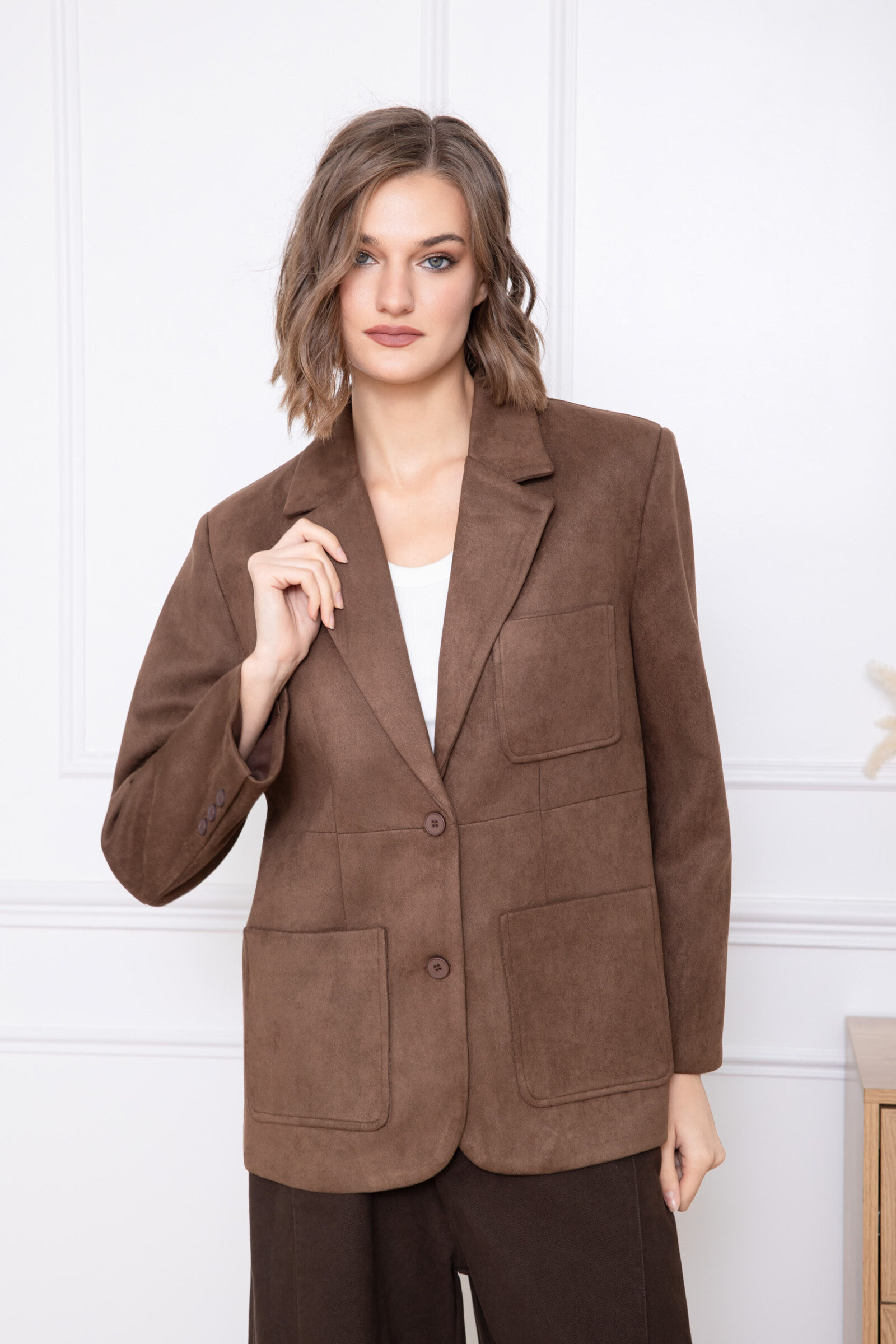 Cette veste de style tailoring se distingue par sa matière en daim au toucher doux et raffiné, offrant une allure élégante et contemporaine. Sa coupe droite et structurée sublime la silhouette tout en garantissant un confort optimal. Le col tailleur classique apporte une note intemporelle, tandis que la fermeture boutonnée sur le devant assure un porté soigné. Les poches plaquées ajoutent à la fois praticité et caractère, renforçant l’esprit chic de la pièce. Une veste polyvalente et sophistiquée, idéale pour composer des tenues élégantes du quotidien ou des ensembles plus habillés.