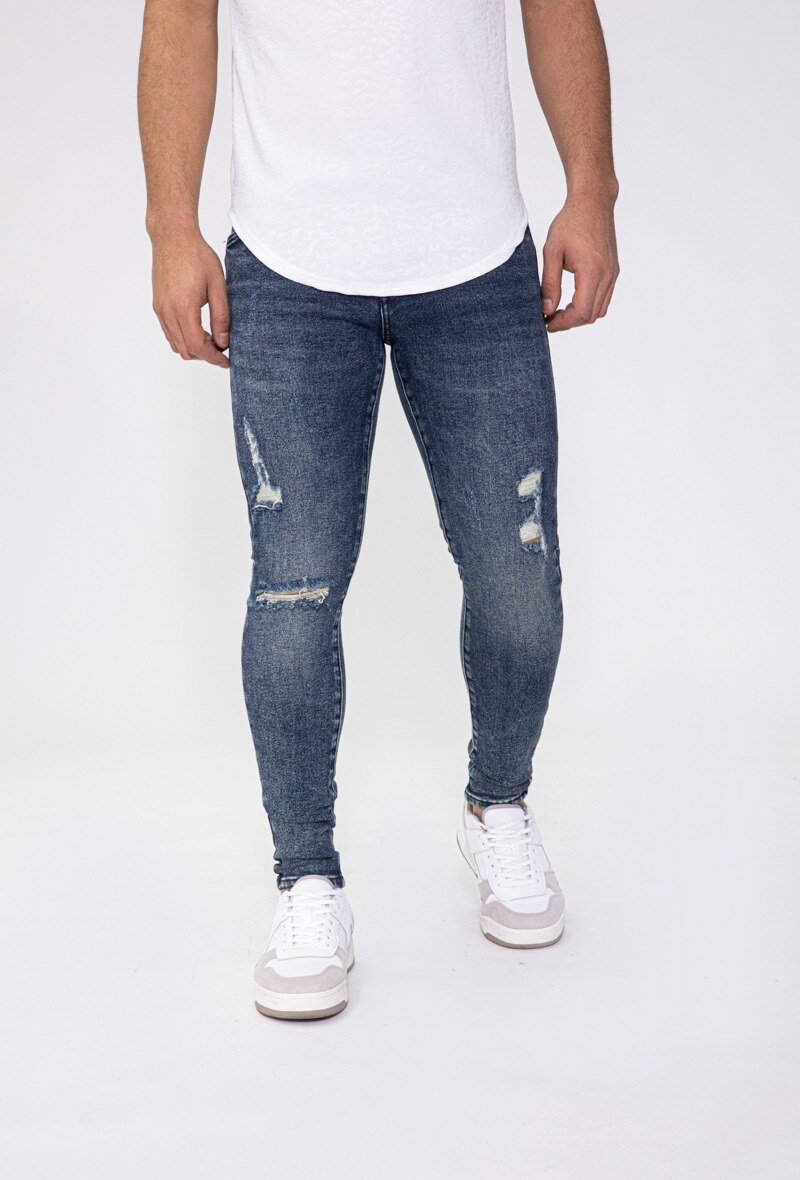 Grossista Frilivin - Jeans skinny stretch con buco